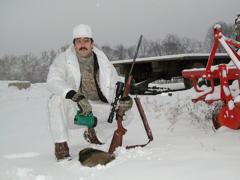 pete hauer in the snow with a raccoon